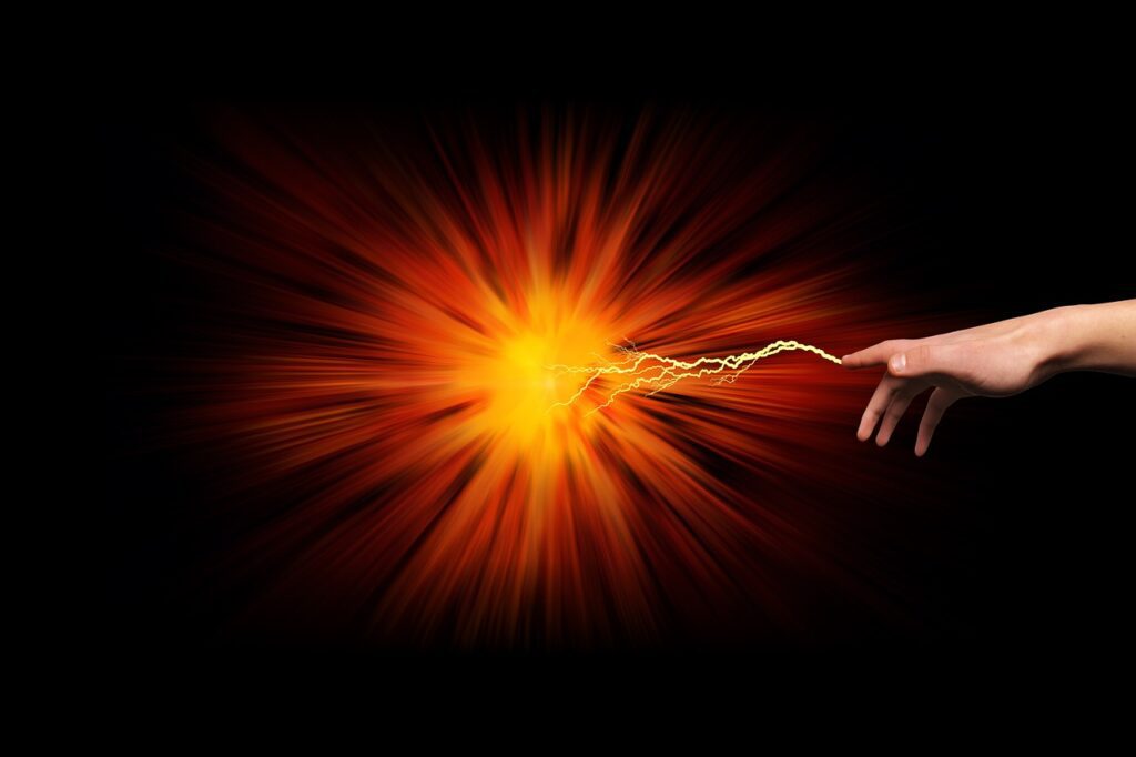 A finger with a lightning bolt coming from it toward an explosion